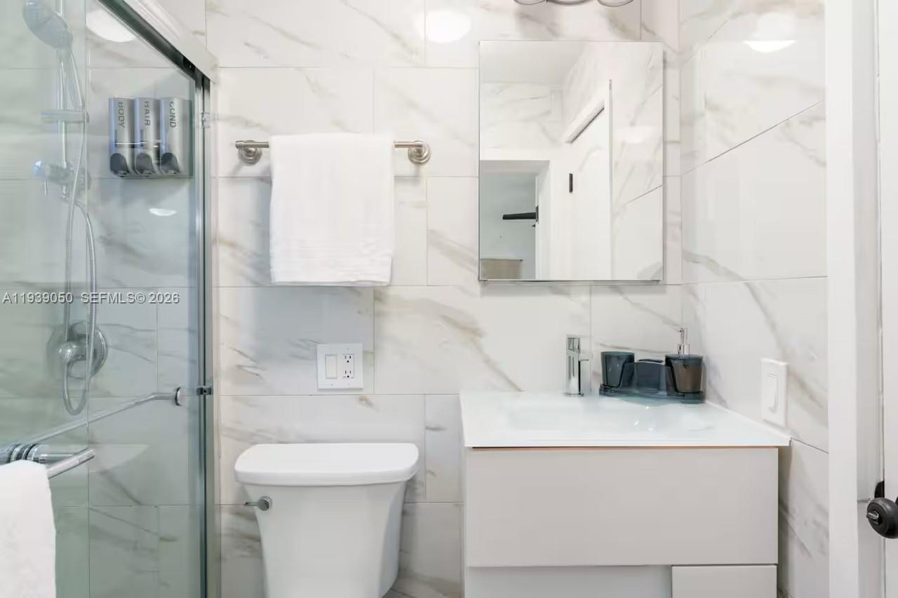 1721 Southwest 11th Terrace Miami, FL 33135 - Photo 56 of 60 a bathroom with a toilet sink and mirror
