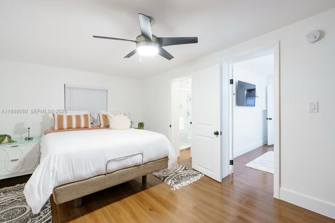 1721 Southwest 11th Terrace Miami, FL 33135 - Photo 58 of 60 a bedroom with a bed and wooden floor