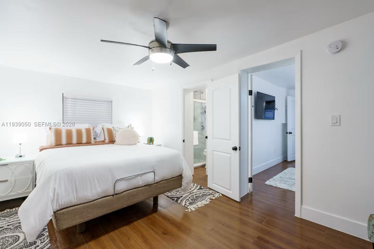 1721 Southwest 11th Terrace Miami, FL 33135 - Photo 59 of 60 a bedroom with a bed and wooden floor