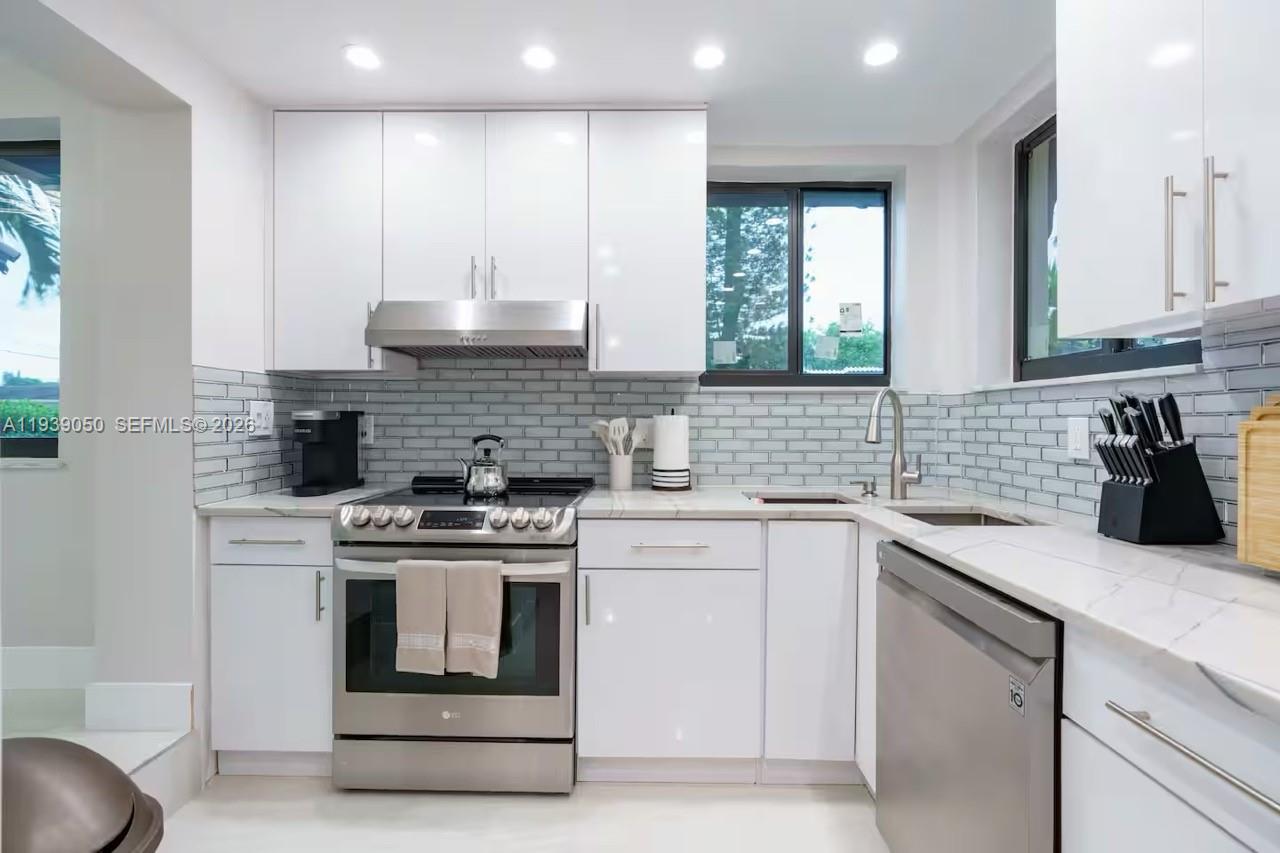 1721 Southwest 11th Terrace Miami, FL 33135 - Photo 6 of 60 a kitchen with appliances a sink and cabinets