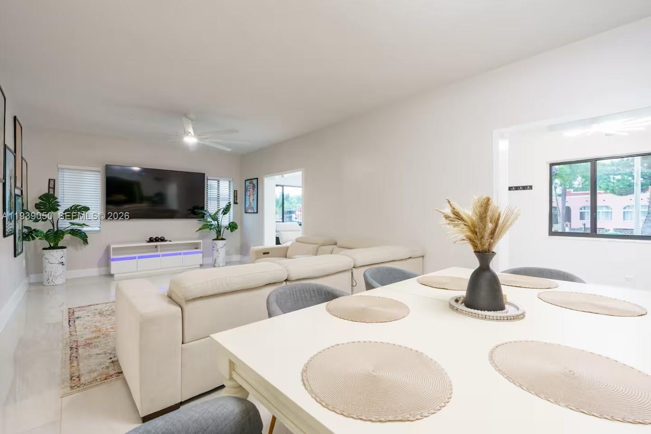 1721 Southwest 11th Terrace Miami, FL 33135 - Photo 10 of 60 a living room with furniture a flat screen tv and a fireplace