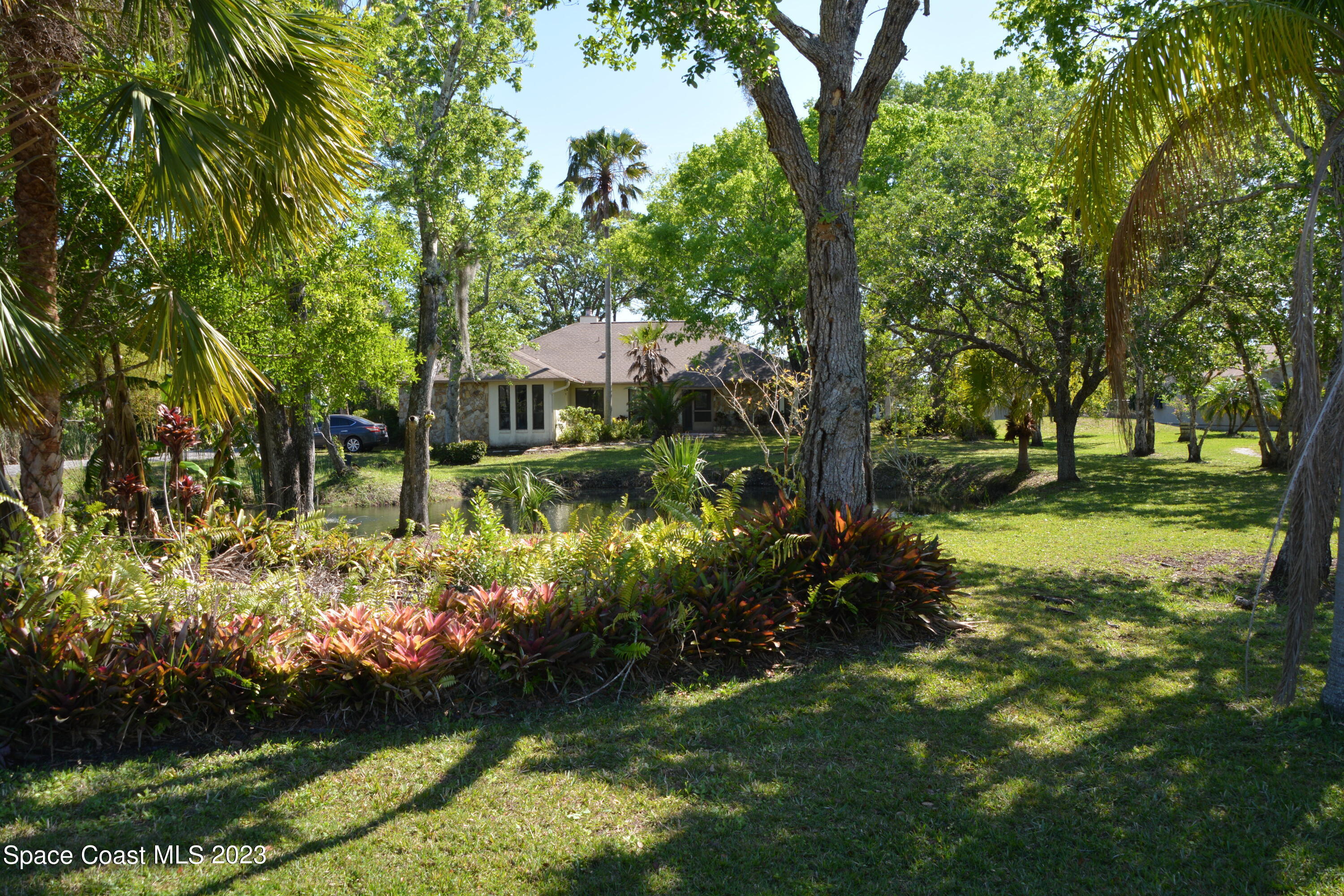 1045 Pine Island Road Merritt Island, FL 32953 - Photo 41 of 42 a view of a large yard with large trees