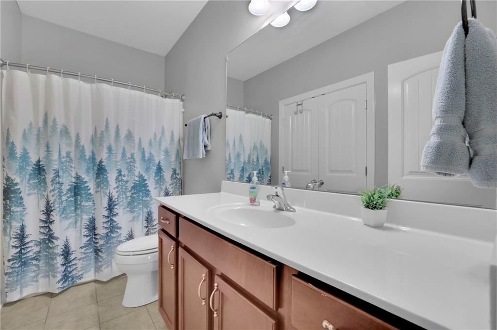 6255 Allison Road Cumming, GA 30040 - Photo 26 of 36 a bathroom with a sink and a mirror