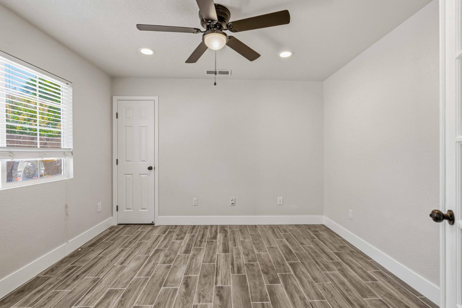1464 Denise Drive Ripon, CA 95366 - Photo 13 of 41 wooden floor in an empty room with a window