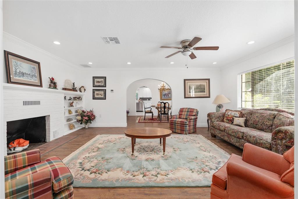 17067 Northwest Gainesville Road Reddick, FL 32686 - Photo 8 of 25 a living room with furniture a fireplace and a large window