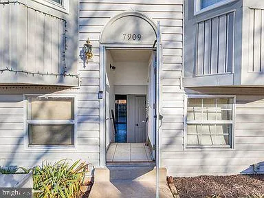 a hallway with a stove a faucet and a fireplace with wooden floor