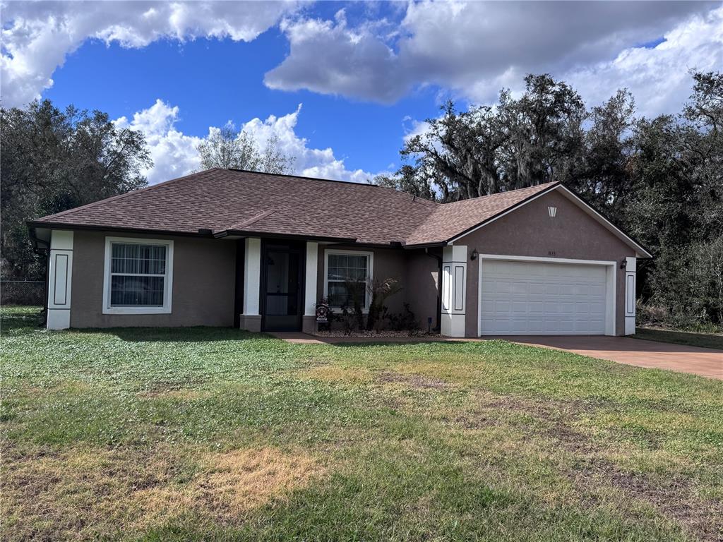 1855 North Berkley Road Avon Park, FL 33825 - Photo 1 of 28 a front view of a house with a garden