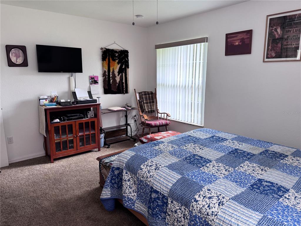 1855 North Berkley Road Avon Park, FL 33825 - Photo 13 of 28 a bedroom with a bed and a television