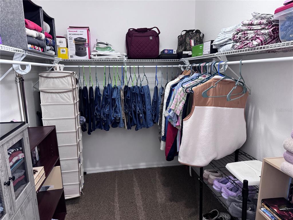 1855 North Berkley Road Avon Park, FL 33825 - Photo 17 of 28 a view of walk in closet with clothes and shoes