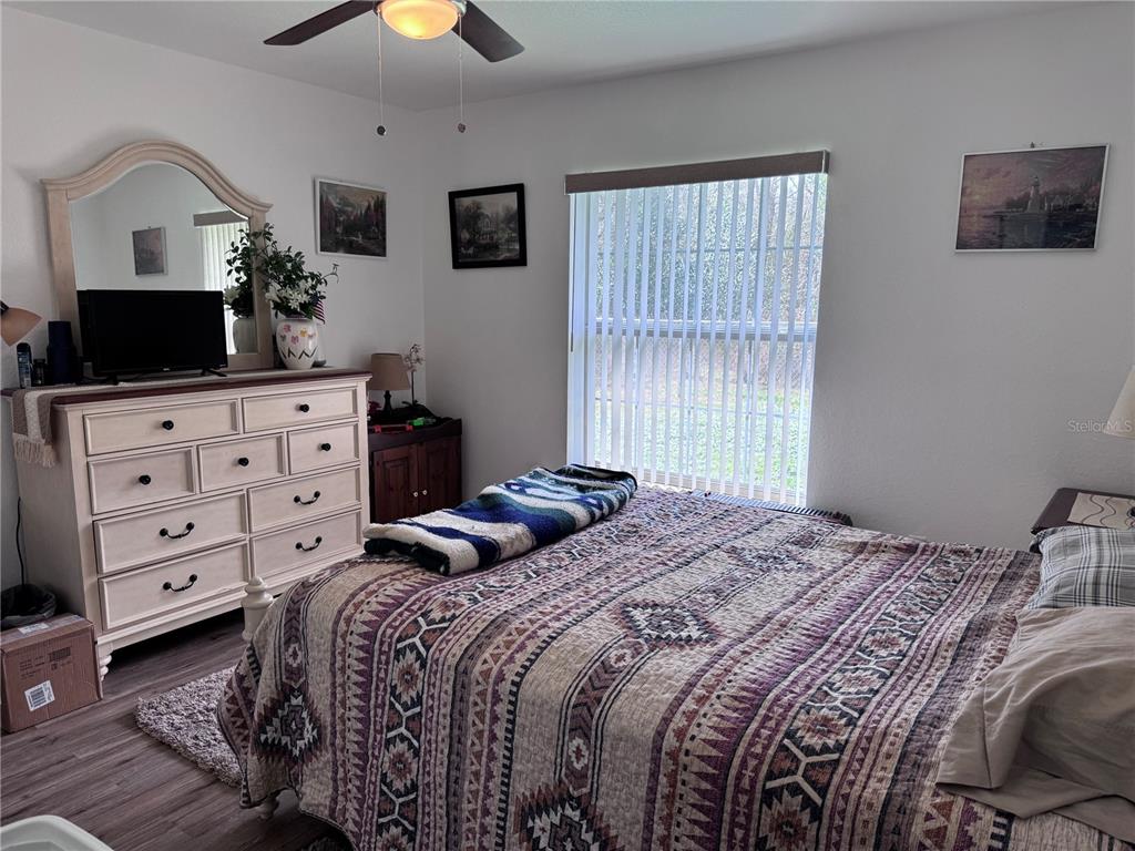 1855 North Berkley Road Avon Park, FL 33825 - Photo 19 of 28 a bedroom with a bed and a flat tv screen on dresser