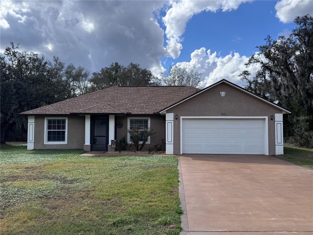 1855 North Berkley Road Avon Park, FL 33825 - Photo 2 of 28 a front view of house with yard and trees in the background