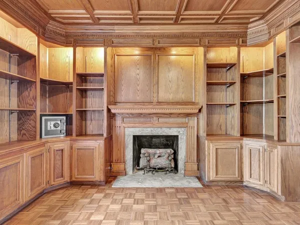 a view of a livingroom with a fireplace and cabinet