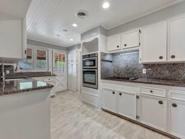 a kitchen with stainless steel appliances granite countertop a stove and a sink