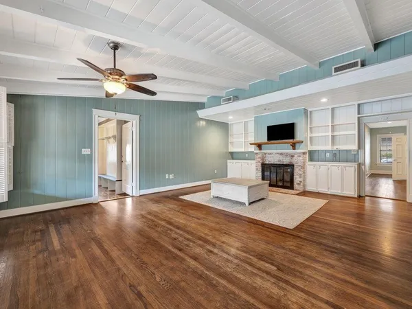 a living room with fireplace furniture and a flat screen tv