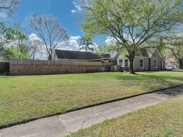 a view of a yard with a house in the background