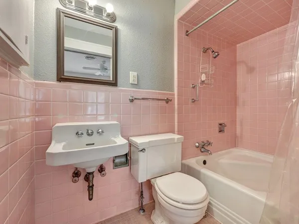 a bathroom with a sink toilet a mirror and shower