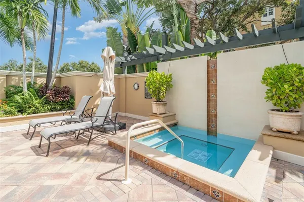 a swimming pool with outdoor seating and yard