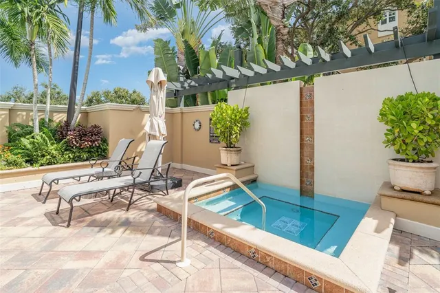 a swimming pool with outdoor seating and yard
