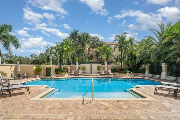 a front view of multi story residential apartment building with yard