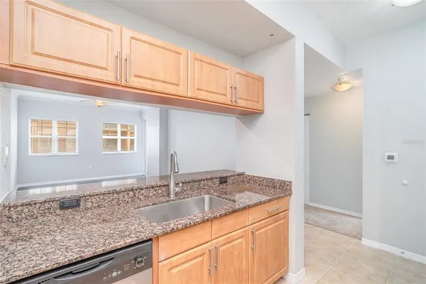 a kitchen with granite countertop a sink and cabinets