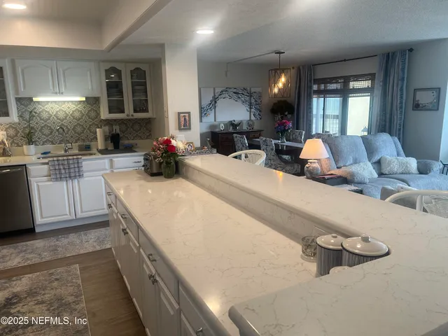 a room with a sink a washer and dryer