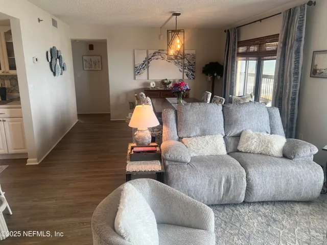 a view of a dining room with furniture and chandelier