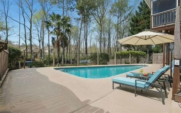 a swimming pool with outdoor seating and yard