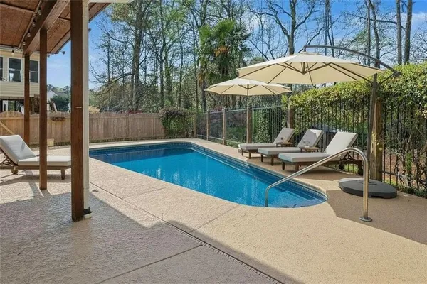 a view of a swimming pool with a lounge chair