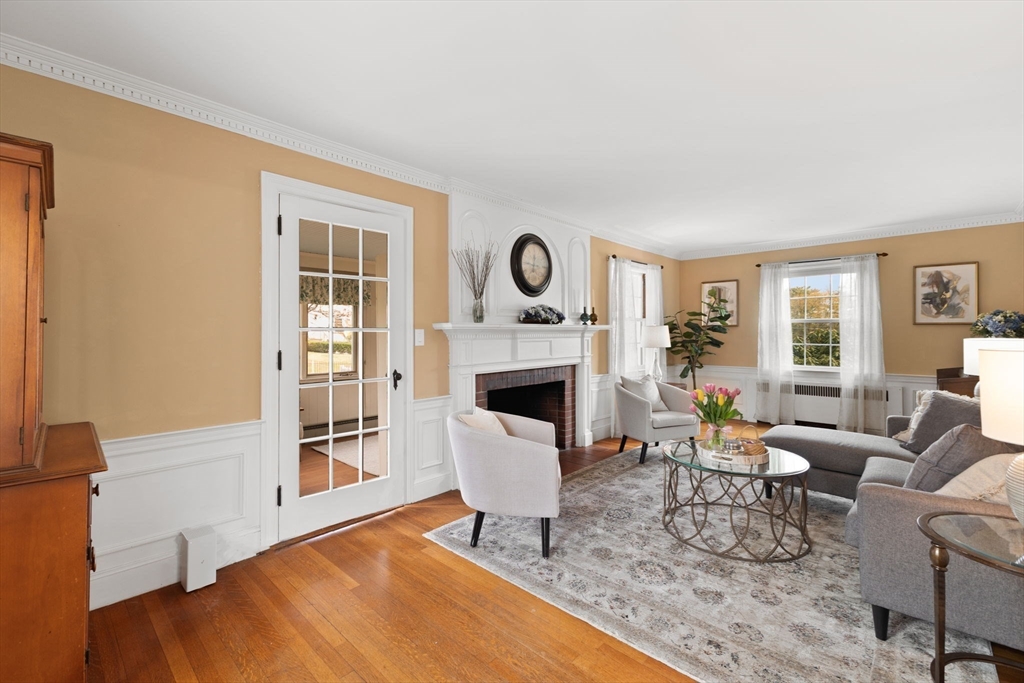 6 Tower Avenue Needham, MA 02494 - Photo 22 of 43 a living room with furniture a fireplace and a table
