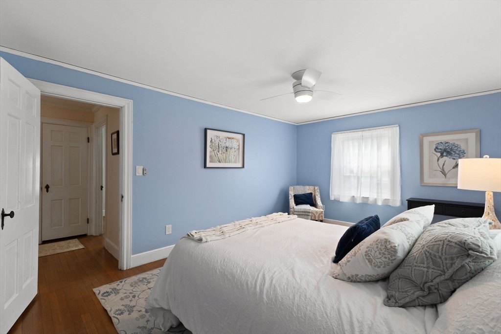 6 Tower Avenue Needham, MA 02494 - Photo 31 of 43 a bedroom with a large bed and a chandelier
