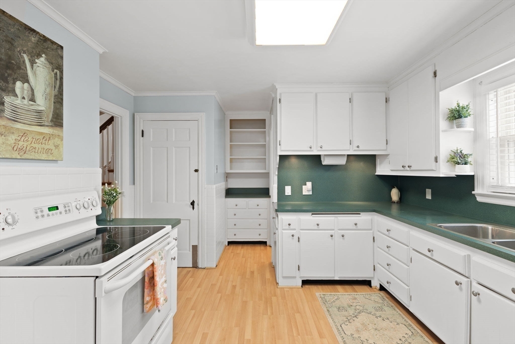 6 Tower Avenue Needham, MA 02494 - Photo 7 of 43 a kitchen with granite countertop a sink a stove and cabinets