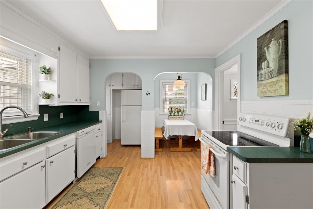 6 Tower Avenue Needham, MA 02494 - Photo 8 of 43 a kitchen with granite countertop a sink stove and cabinets