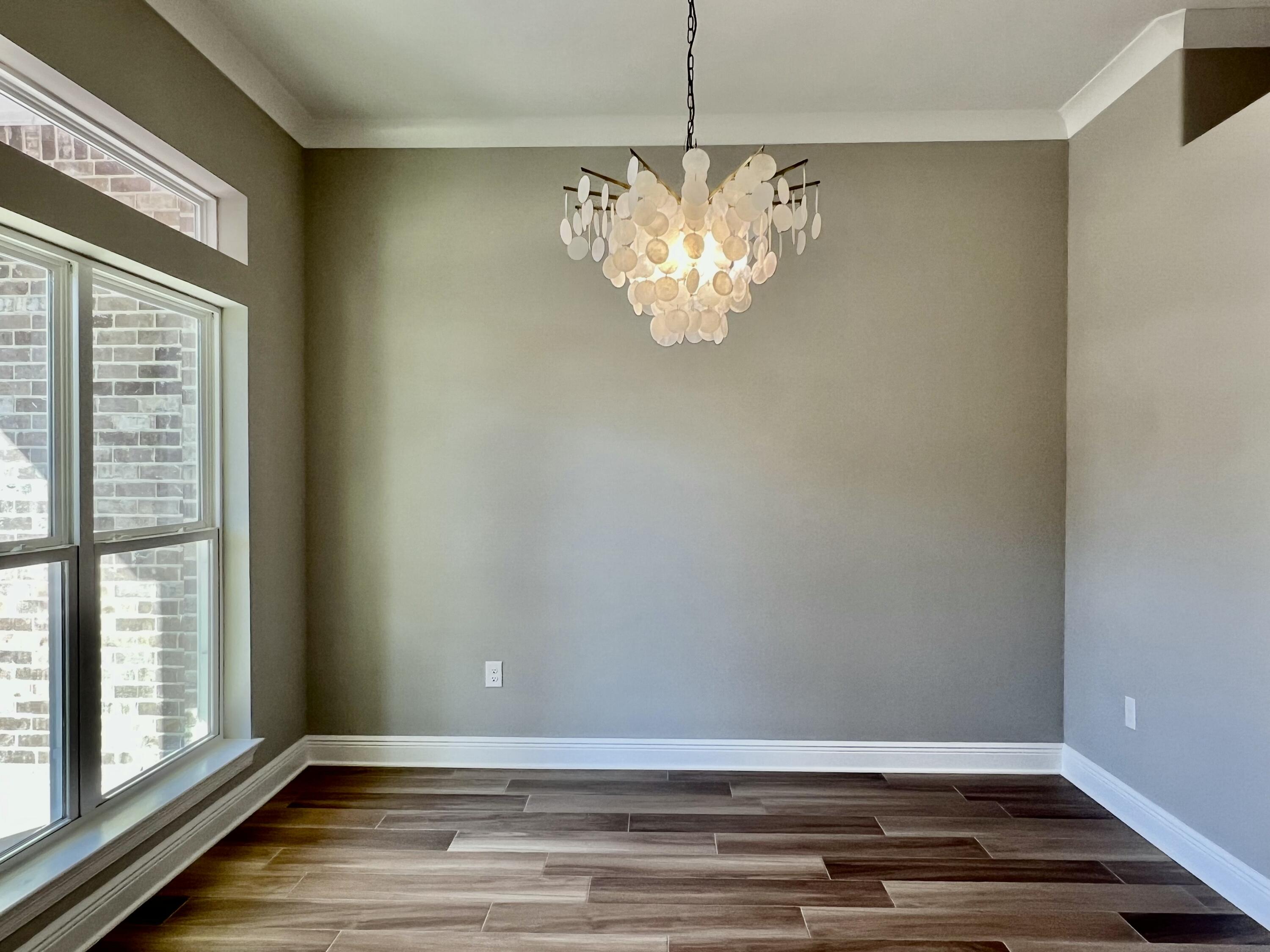2038 Colby Court Navarre, FL 32566 - Photo 12 of 51 a view of wooden floor and windows in a room