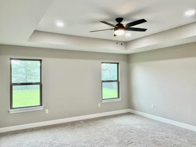 a spacious bathroom with a granite countertop double vanity sink and a mirror