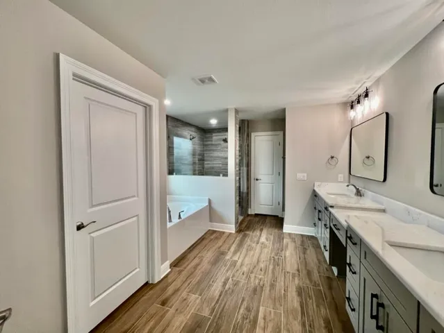 a bathroom with a double vanity sink and mirror