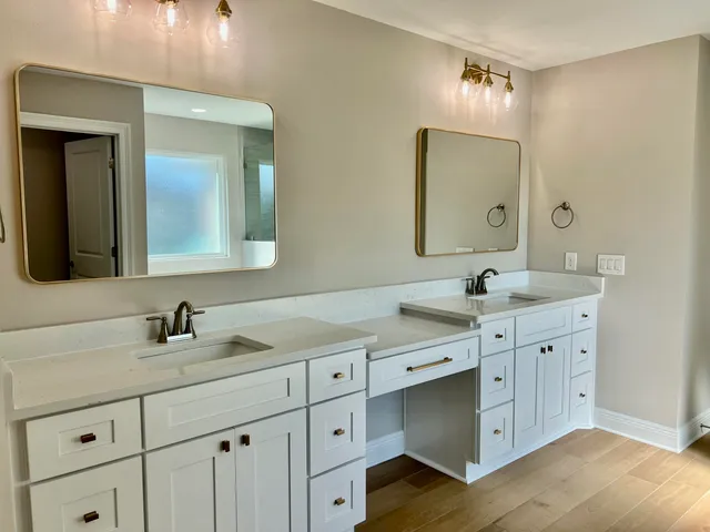 a bathroom with a double vanity sink and mirror