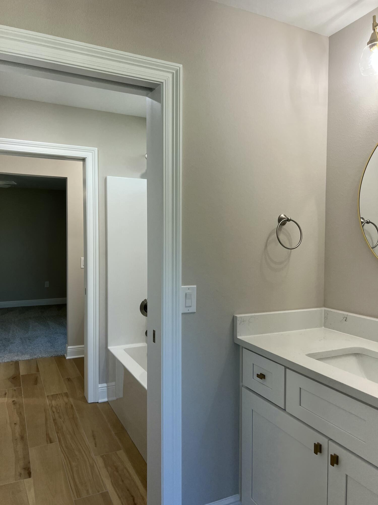 2038 Colby Court Navarre, FL 32566 - Photo 22 of 51 a bathroom with a sink and mirror