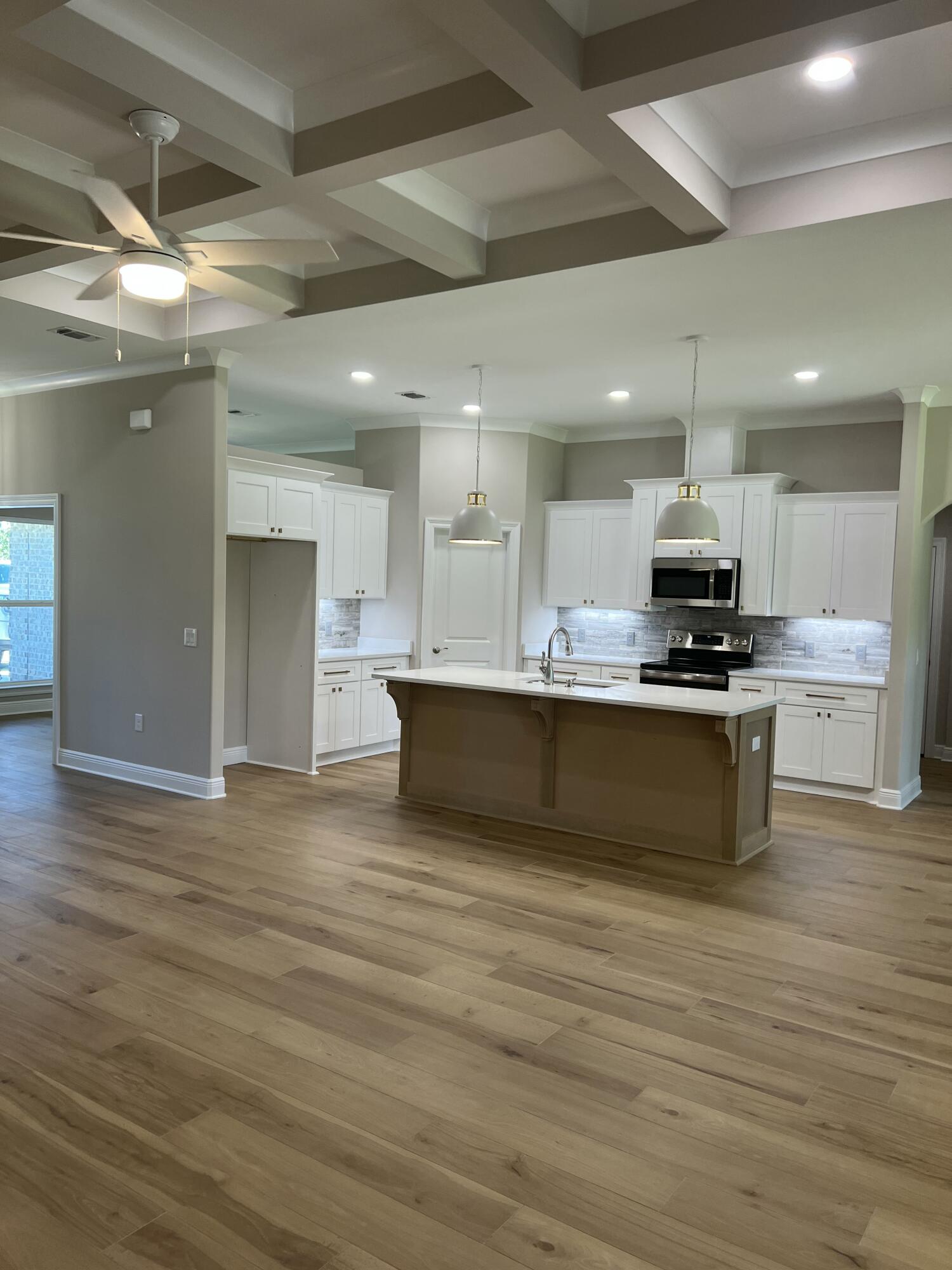 2038 Colby Court Navarre, FL 32566 - Photo 9 of 51 a large kitchen with kitchen island a sink stainless steel appliances and cabinets