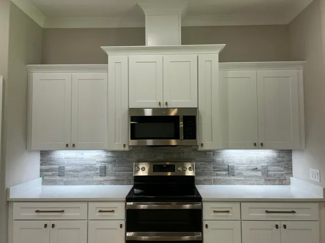 an empty room with wooden floor chandelier and closet