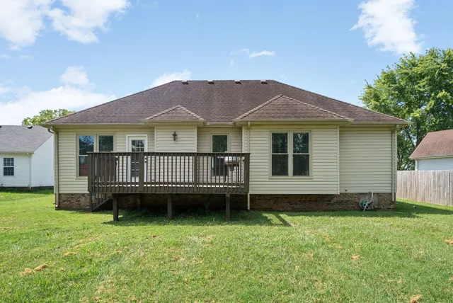 a view of a house with a backyard and a garden
