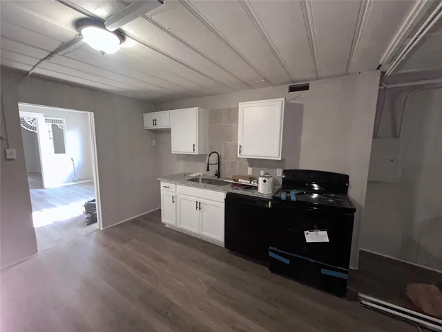 a kitchen with sink and cabinets