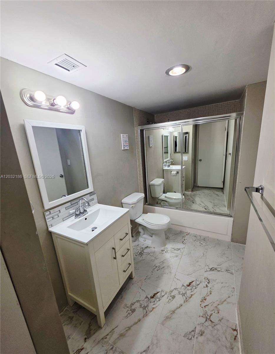 4164 Inverrary Drive, Unit 204 Lauderhill, FL 33319 - Photo 17 of 28 a bathroom with a sink a toilet and mirror
