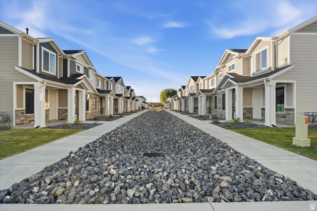 2257 South 1090 West, Unit 74 Nibley, UT 84321 - Photo 22 of 40 Row of contemporary townhomes featuring multi-toned siding and stone veneer accents