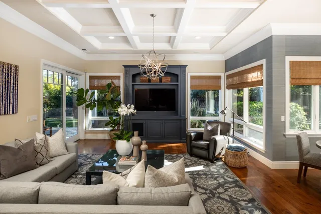 a living room with patio furniture and a flat screen tv
