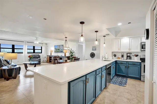 a kitchen with stainless steel appliances kitchen island granite countertop a sink and cabinets