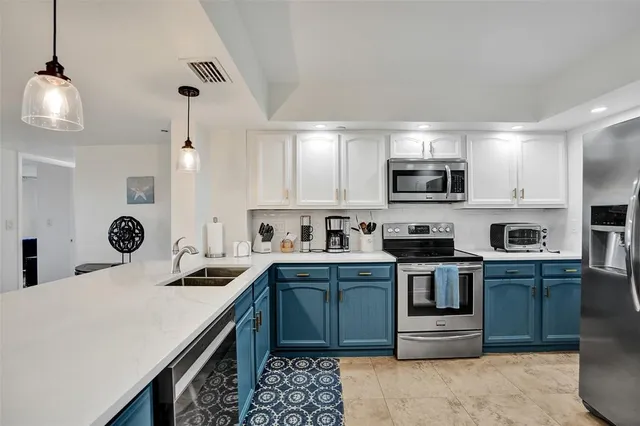 a kitchen with a sink stove top oven and microwave