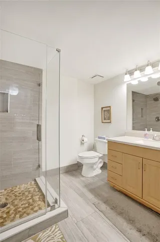 a spacious bathroom with a shower and a sink