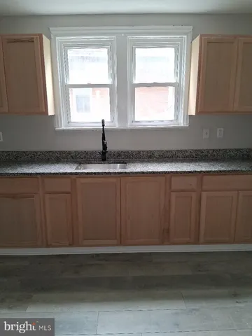 a view of a kitchen with granite countertop cabinets and window