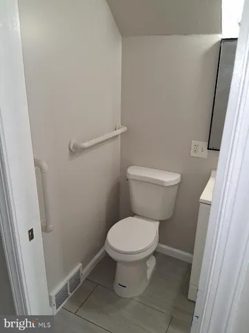 a white toilet sitting next to a sink