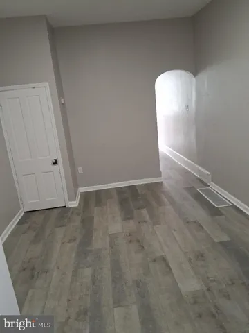 a view of a room with wooden floor